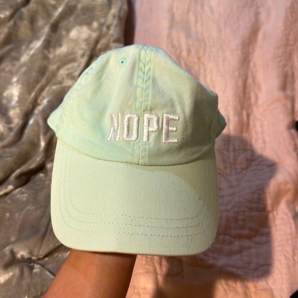 Vs pink hat that says “nope”
